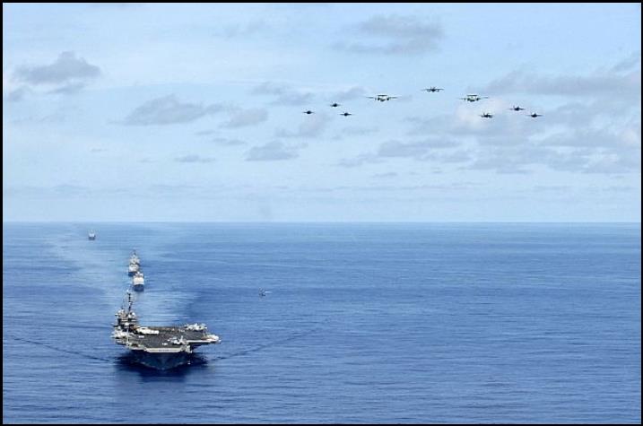 Aircraft assigned to Carrier Air Wing 5 fly over USS Kitty Hawk (CV 63), USS Cowpens (CG 63), USS Mustin (DDG 89), USS Curtis Wilbur (DDG 54), and USNS Pecos (T-AO 197).