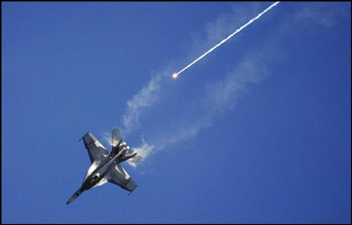 An F/A-18F Super Hornet, assigned to Strike Fighter Squadron (VFA) 102, fires off its flares while performing evasive maneuvers during an air power demonstration.