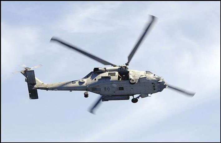An SH-60F Seahawk, assigned to Helicopter Anti-Submarine Squadron (HS) 14, flies through the air acting as plane guard for USS Kitty Hawk (CV 63) during an air power demonstration.