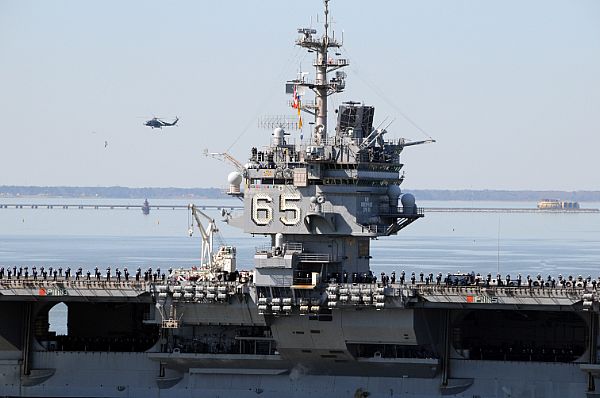 Sailors man the rails as the aircraft carrier USS Enterprise (CVN 65) departs Naval Station Norfolk for its final deployment.