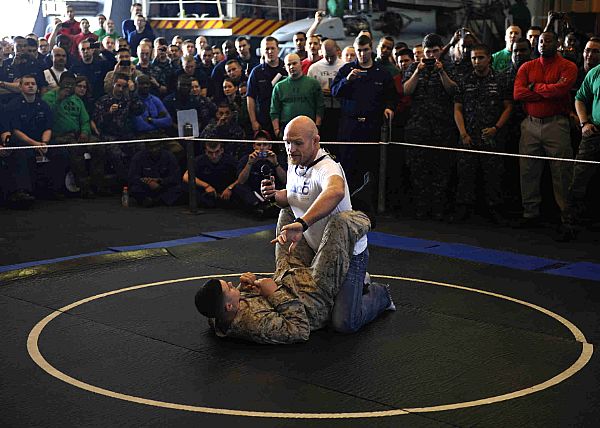 Ultimate Fighting Championship (UFC) fighter Keith Jardine demonstrates grappling moves during an exhibition in the hangar bay aboard aircraft carrier USS Enterprise (CVN 65).
