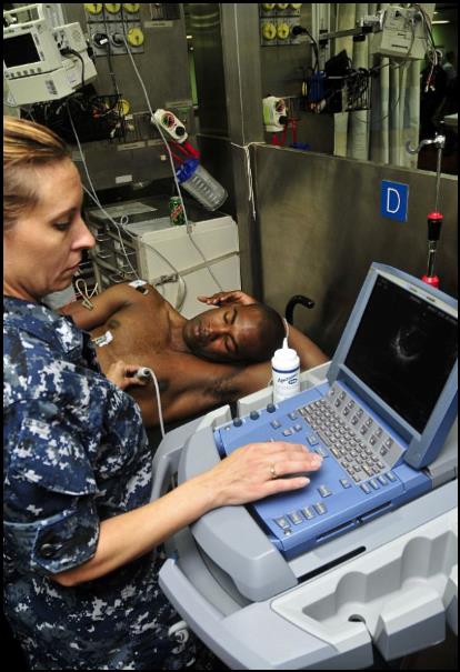 Hospital Corpsman 1st Class Seana Carbone examines a patient's heart during a surgical civil action project training exercise.