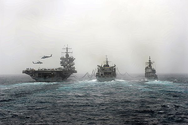 The aircraft carrier USS Enterprise (CVN-65), left, and the guided-missile cruiser USS Vicksburg (CG-69), right, conduct a replenishment at sea with the Military Sealift Command fast combat support ship USNS Supply (T-AOE 6).