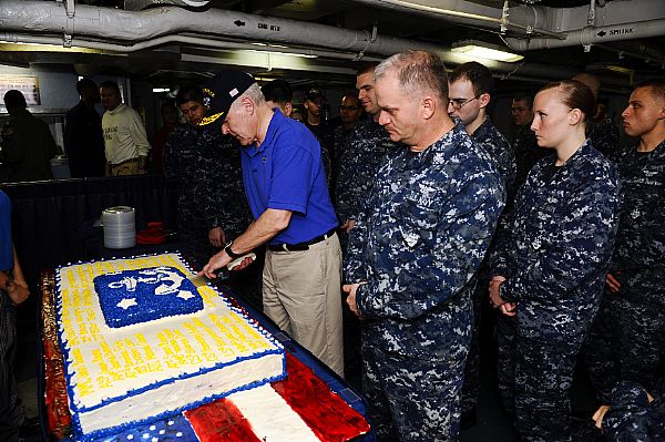 Secretary of the Navy (SECNAV) Ray Mabus cuts a specially made cake honoring his visit to the aircraft carrier USS Enterprise (CVN 65).