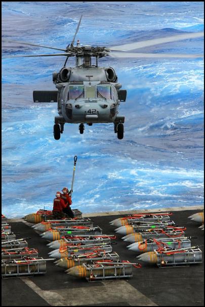 An MH-60S Sea Hawk helicopter assigned to the Dragon Whales of Helicopter Sea Combat Squadron (HSC) 28 picks up ammunition from the aircraft carrier USS Enterprise (CVN 65) during the carrier's last ammunition offload.