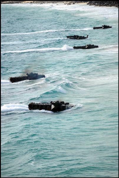 Marines assigned to Amphibious Assault Vehicle platoon, Combat Assault Company, 3rd Marine Regiment, storm a beach during Rim of the Pacific (RIMPAC) 2012.